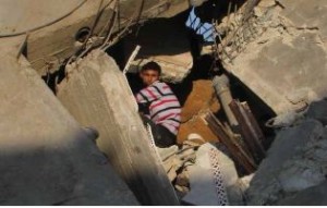 A child looks for his belongings inside his devastated home