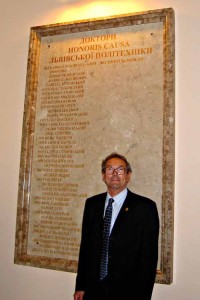 Professor Tim Mason in front of the role of honours board at the Lviv Polytechnic National University.