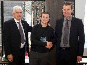 JSW Academy Leader Paul Millington (left) and J S Wright Director Phil Leech congratulate Scott Ramm on receiving his trophy for being voted BEST Apprentice Plumber for London and the South East for 2012.