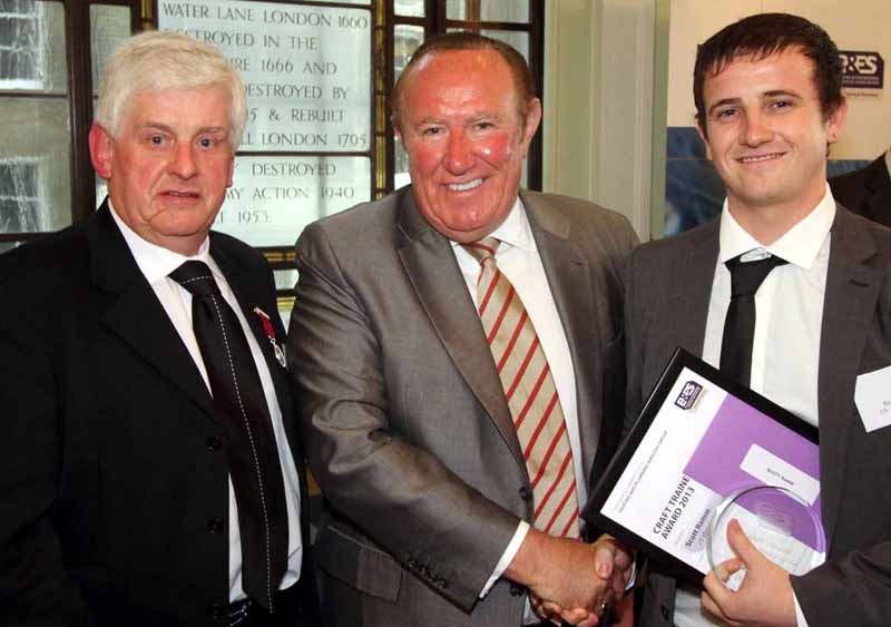 Scott Ramm (right) receives his award from Andrew Neil in the company of Heating and Plumbing Services Group Chairman John Hurst (left)